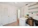 A bright bedroom offers a ceiling fan, closet, extra storage shelves, and access to other rooms at 37722 Granada Ave, Dade City, FL 33525