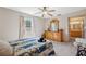 Comfortable bedroom featuring a ceiling fan, dresser, and large window at 37722 Granada Ave, Dade City, FL 33525