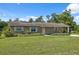 Charming single-story home with a well-maintained lawn and attached carport at 37722 Granada Ave, Dade City, FL 33525