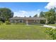 Well-maintained single-story home featuring an attached carport and manicured front yard at 37722 Granada Ave, Dade City, FL 33525