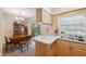 Bright kitchen with wood cabinets, adjacent to a dining area with vintage hutch at 37722 Granada Ave, Dade City, FL 33525