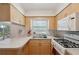 Bright kitchen features white appliances, light wood cabinets, and a stainless steel sink at 37722 Granada Ave, Dade City, FL 33525