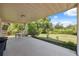 Spacious covered patio ideal for entertaining and enjoying the beautifully landscaped backyard with lush greenery at 37722 Granada Ave, Dade City, FL 33525