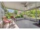 Relaxing screened-in porch offers a serene outdoor space with comfortable seating and views of the lush backyard at 37722 Granada Ave, Dade City, FL 33525