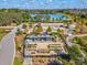 Aerial view of the community garden, showcasing its layout with a pond, park, and garden plots at 3897 Villamore Ln, Odessa, FL 33556