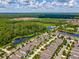 Aerial view of home showcasing the neighborhood, nearby lake, and mature trees at 3897 Villamore Ln, Odessa, FL 33556