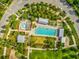 Aerial view of a community pool area with a splash pad, lap pool, and ample seating at 3897 Villamore Ln, Odessa, FL 33556