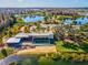 Stunning aerial view of a lakefront community building with modern architecture and lush landscaping at 3897 Villamore Ln, Odessa, FL 33556