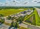 Aerial view of a commercial development with well-maintained landscaping and ample parking at 3897 Villamore Ln, Odessa, FL 33556