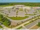 Aerial view of a school with spacious parking and modern buildings, nestled in a green landscape at 3897 Villamore Ln, Odessa, FL 33556