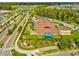 Aerial view of a school with a large parking lot, playground, and sports fields at 3897 Villamore Ln, Odessa, FL 33556