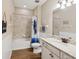 Bathroom with granite countertops, wood look flooring and a shower tub combo at 3897 Villamore Ln, Odessa, FL 33556