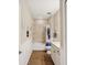 Bathroom with white wainscoting, a tub shower and stylish tile flooring at 3897 Villamore Ln, Odessa, FL 33556