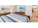 Bedroom with blue and white bedding, ensuite and flat screen television at 3897 Villamore Ln, Odessa, FL 33556