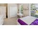 Bedroom featuring a white closet, desk, large windows, and a purple comforter at 3897 Villamore Ln, Odessa, FL 33556