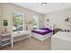 Bright bedroom with a white desk, white bookcase bed frame and lots of natural light at 3897 Villamore Ln, Odessa, FL 33556