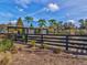 Community garden with raised beds and a covered area, fenced for secure and enjoyable gardening at 3897 Villamore Ln, Odessa, FL 33556