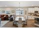 Open concept dining area features a modern table and hardwood flooring at 3897 Villamore Ln, Odessa, FL 33556