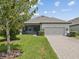 Charming single-story home with a well-maintained lawn and a two-car garage at 3897 Villamore Ln, Odessa, FL 33556