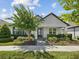 Charming single-story home boasts a well-manicured lawn, inviting entrance, and lush landscaping at 3897 Villamore Ln, Odessa, FL 33556