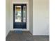 Inviting front porch with double glass doors, brick pavers, and a 'HELLO' doormat at 3897 Villamore Ln, Odessa, FL 33556