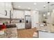 Bright kitchen offers granite countertops, stainless appliances and sleek white cabinetry at 3897 Villamore Ln, Odessa, FL 33556