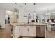 Kitchen island features granite counters, seating and stainless steel dishwasher at 3897 Villamore Ln, Odessa, FL 33556