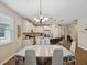 Open-concept kitchen featuring a dining area, center island with bar seating, and stainless steel appliances at 3897 Villamore Ln, Odessa, FL 33556
