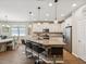 Bright, open kitchen with a large island, white cabinetry, stainless steel appliances, and bar stool seating at 3897 Villamore Ln, Odessa, FL 33556