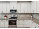 Gourmet kitchen features granite counters, stainless appliances and tiled backsplash at 3897 Villamore Ln, Odessa, FL 33556