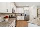 Modern kitchen features stainless appliances, granite counters and white cabinets at 3897 Villamore Ln, Odessa, FL 33556