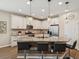 Stylish kitchen features a large island, granite countertops, stainless appliances, and elegant pendant lighting at 3897 Villamore Ln, Odessa, FL 33556