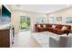 Cozy living room with a comfortable sectional sofa, tile flooring, and a view of the outdoor patio at 3897 Villamore Ln, Odessa, FL 33556