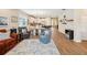 Open concept living area with wood-look flooring, furniture, kitchen, and dining area at 3897 Villamore Ln, Odessa, FL 33556