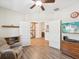 Inviting living room featuring wood flooring, comfortable seating, and a view into an additional room at 3897 Villamore Ln, Odessa, FL 33556