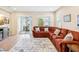 Spacious living room features a comfortable red couch, neutral walls, and light-colored flooring at 3897 Villamore Ln, Odessa, FL 33556