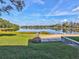 Scenic view of a tranquil pond surrounded by lush greenery and trees, offering a peaceful retreat at 3897 Villamore Ln, Odessa, FL 33556