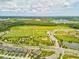 Aerial view of sports fields and a pond amidst green spaces providing outdoor activities for an active lifestyle at 3897 Villamore Ln, Odessa, FL 33556
