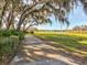 Picturesque walking path with a wooden boardwalk leading to a serene lake at 3897 Villamore Ln, Odessa, FL 33556