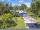 Aerial view of a home, detached garage, and well maintained lawn at 4007 S Renellie Dr, Tampa, FL 33611