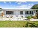 Backyard patio with chairs, a small table, and a lush lawn at 4007 S Renellie Dr, Tampa, FL 33611