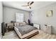 Bedroom featuring ceiling fan, light gray walls, and a decorative gray comforter on the bed at 4007 S Renellie Dr, Tampa, FL 33611