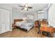 Bedroom with wood floors, fan, and a wooden desk with a chair at 4007 S Renellie Dr, Tampa, FL 33611