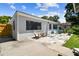 Charming single-story home featuring a concrete patio with seating and a well-maintained exterior at 4007 S Renellie Dr, Tampa, FL 33611