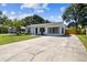 Exterior view of home featuring well-maintained lawn and long driveway at 4007 S Renellie Dr, Tampa, FL 33611