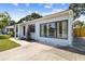 Exterior view of this well-maintained home showcasing a lush lawn and walkway at 4007 S Renellie Dr, Tampa, FL 33611