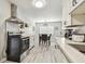 Bright kitchen featuring stainless steel appliances, sleek white cabinets and dining area at 4007 S Renellie Dr, Tampa, FL 33611