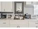 Close-up of kitchen with a stainless steel sink and small appliances on marble countertops at 4007 S Renellie Dr, Tampa, FL 33611