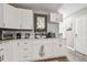 Bright kitchen with white cabinets, marble countertops, and stainless steel appliances at 4007 S Renellie Dr, Tampa, FL 33611