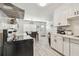 Open kitchen and dining area with modern appliances, stylish cabinets, and sleek finishes at 4007 S Renellie Dr, Tampa, FL 33611